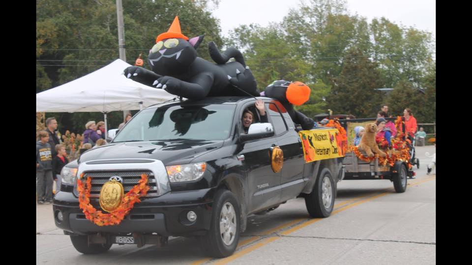 Mishicot Veterinary Clinic - Photo of Parade with Black Truck and Orange Balloons